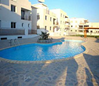 Apartment complex with communal swimming pool and beautiful landscaping in Oroklini village