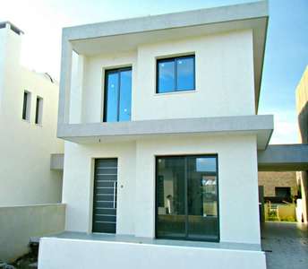 Contemporary house with a minimal design, featuring large windows and a side access road leading to the covered parking