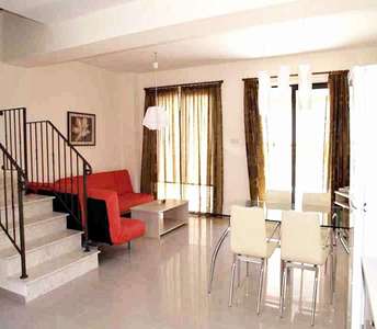 Townhouse interior in Famagusta province with open-plan layout and earth-toned furniture