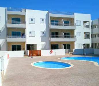Central communal pools in a residential complex in Famagusta province surrounded by two-storey buildings