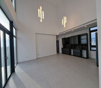 Open-plan layout with high ceilings offering natural light