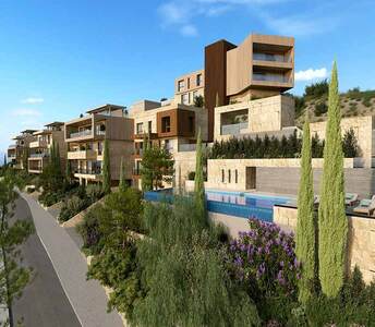 Mediterranean landscape framing a tiered cluster of apartment buildings with angular lines and private terraces