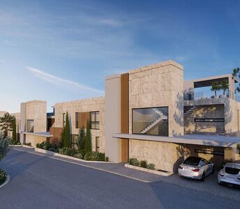 Rear elevation of the development with clean stone façades, linear volumes and access from the upper road