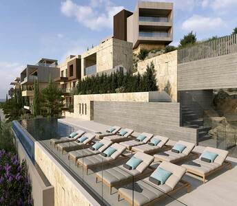 Infinity pool and large terrace overlooking the tiered architecture of a luxury residential complex in Limassol