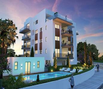 Contemporary block of flats with infinity swimming pool and landscaped garden