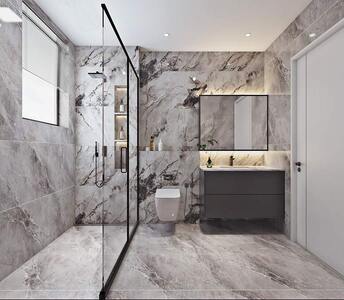 Sleek bathroom featuring luxurious marble finishes, a modern walk-in shower, and wall-hung toilet