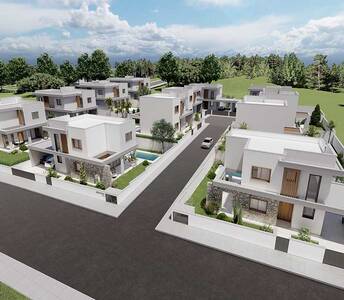 Aerial view of detached villas with stone façades and private gardens near the pine forest in Souni village