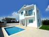 Back view of the house with modern architectural lines, spacious outdoor space, and a swimming pool