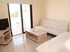 Compact living room with light furnishings and access to private patio in Famagusta province